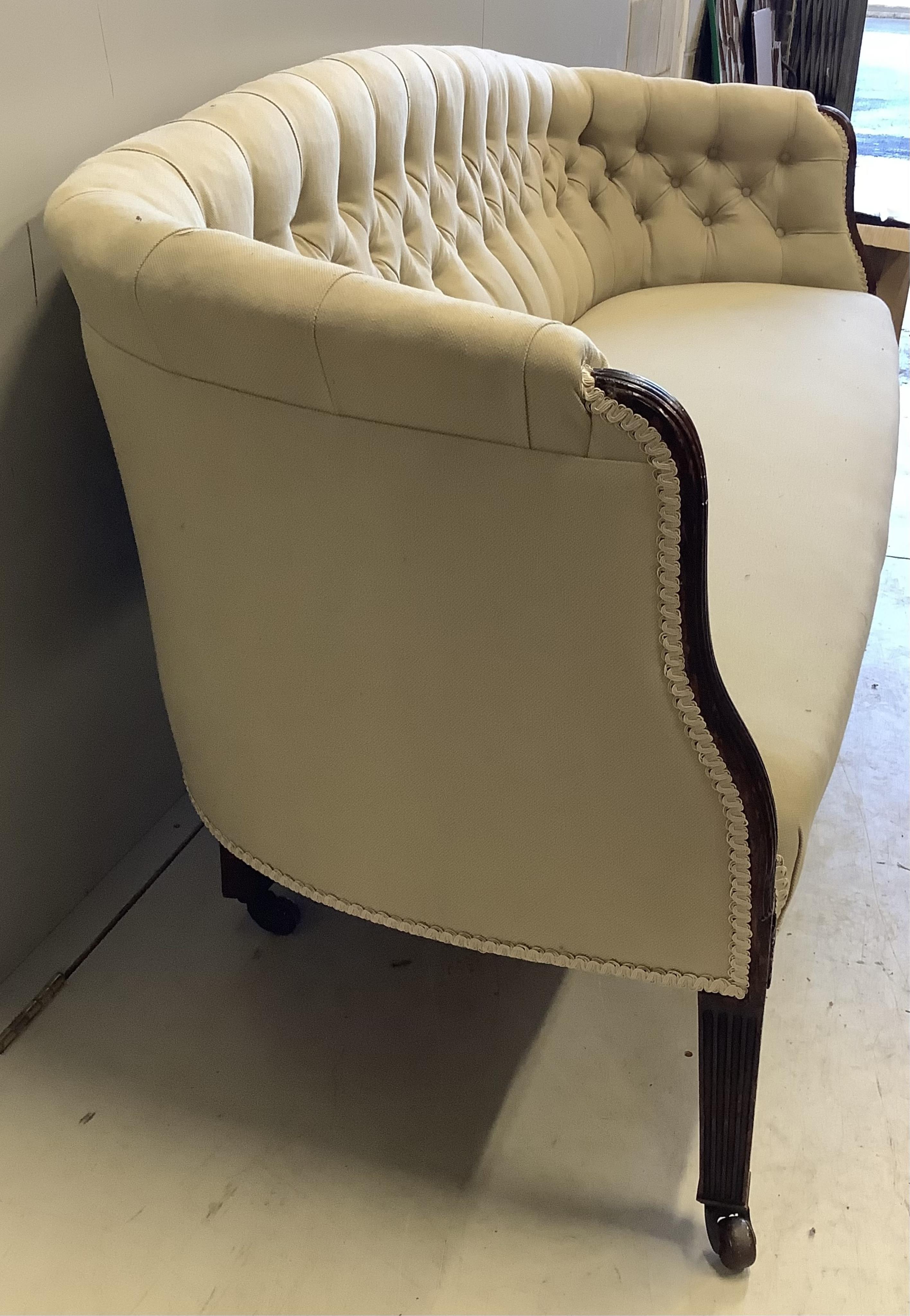 A George III mahogany settee, recently re-upholstered, width 204cm, depth 68cm, height 74cm. Condition - good